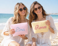 Personalized pink and yellow seersucker makeup bags for bridesmaids at the beach