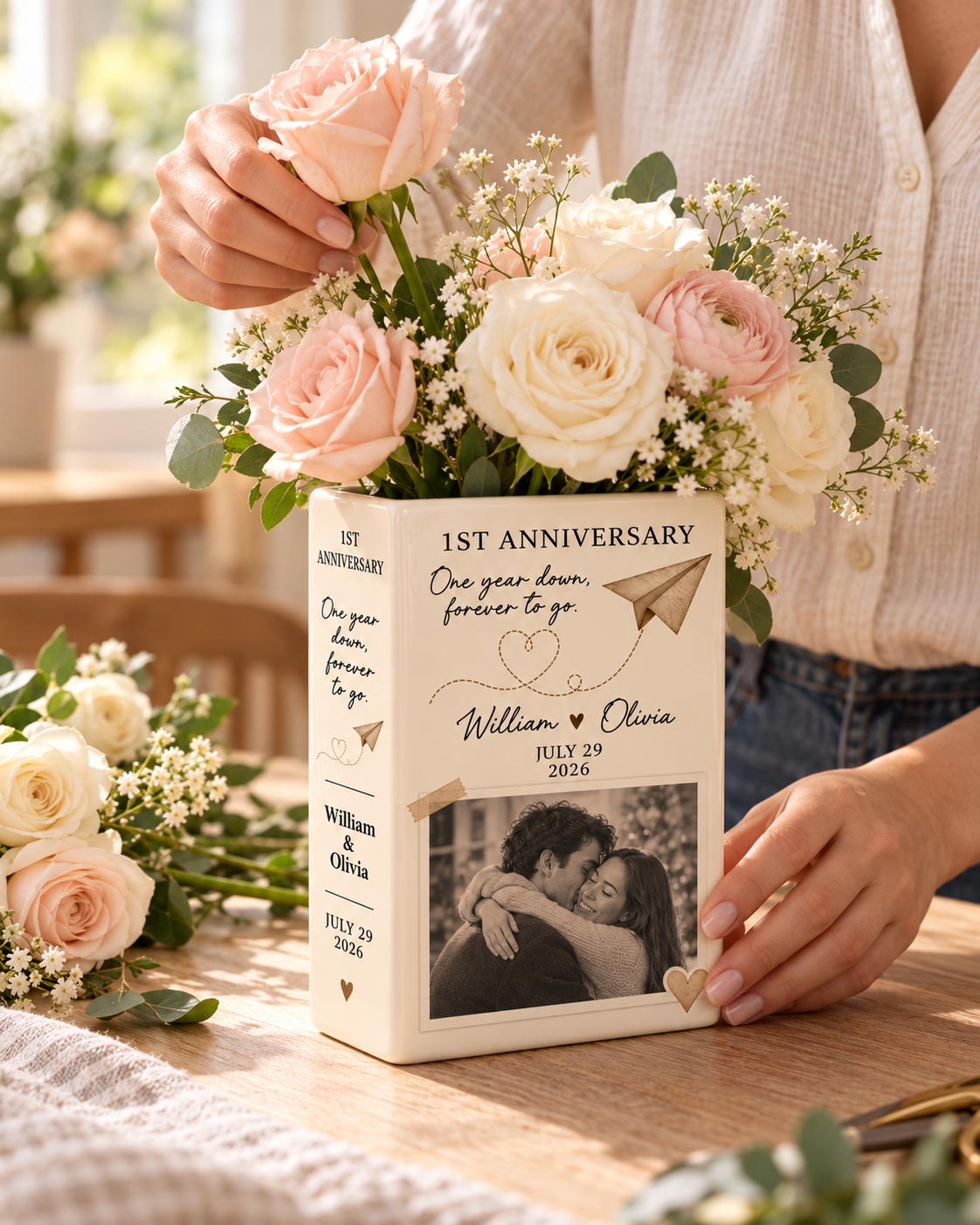 Custom couple photo 1st anniversary ceramic book vase being arranged with flowers