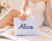 Personalized baby blue seersucker makeup bag embroidered with the name Alice