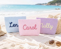 Custom embroidered seersucker makeup bags in blue pink and purple