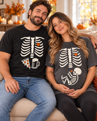 Matching skeleton pregnancy announcement couple tees in autumn setting