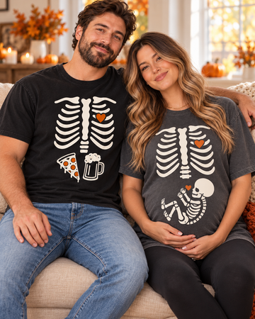Matching skeleton pregnancy announcement couple tees in autumn setting
