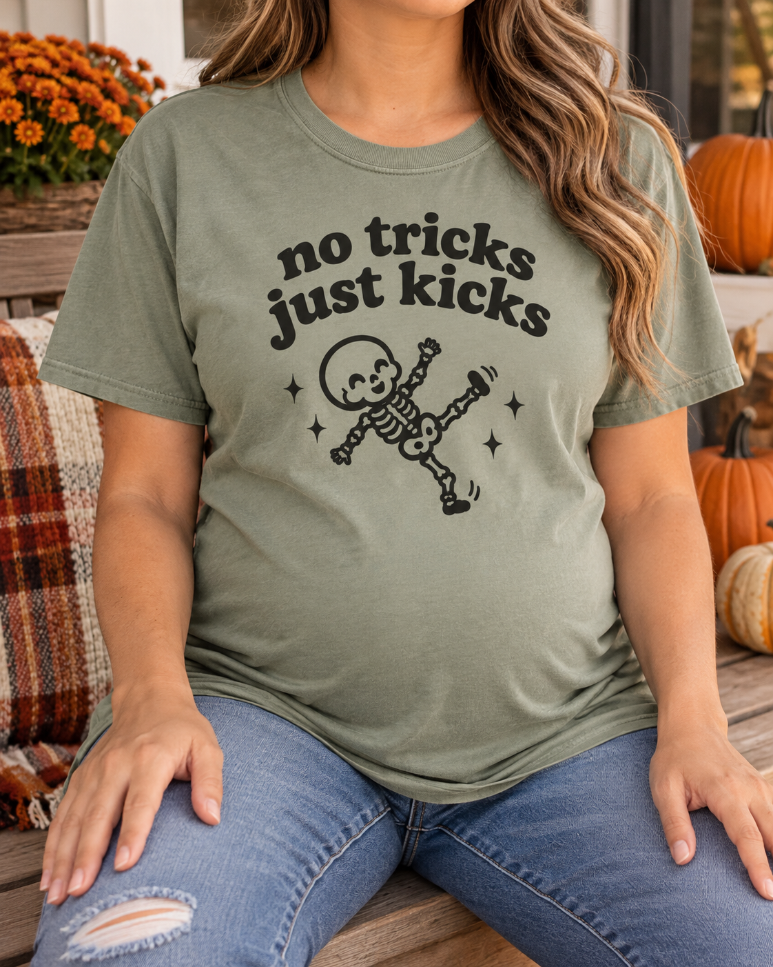 Pregnant model wearing No Tricks Just Kicks skeleton Comfort Colors tee in Sage