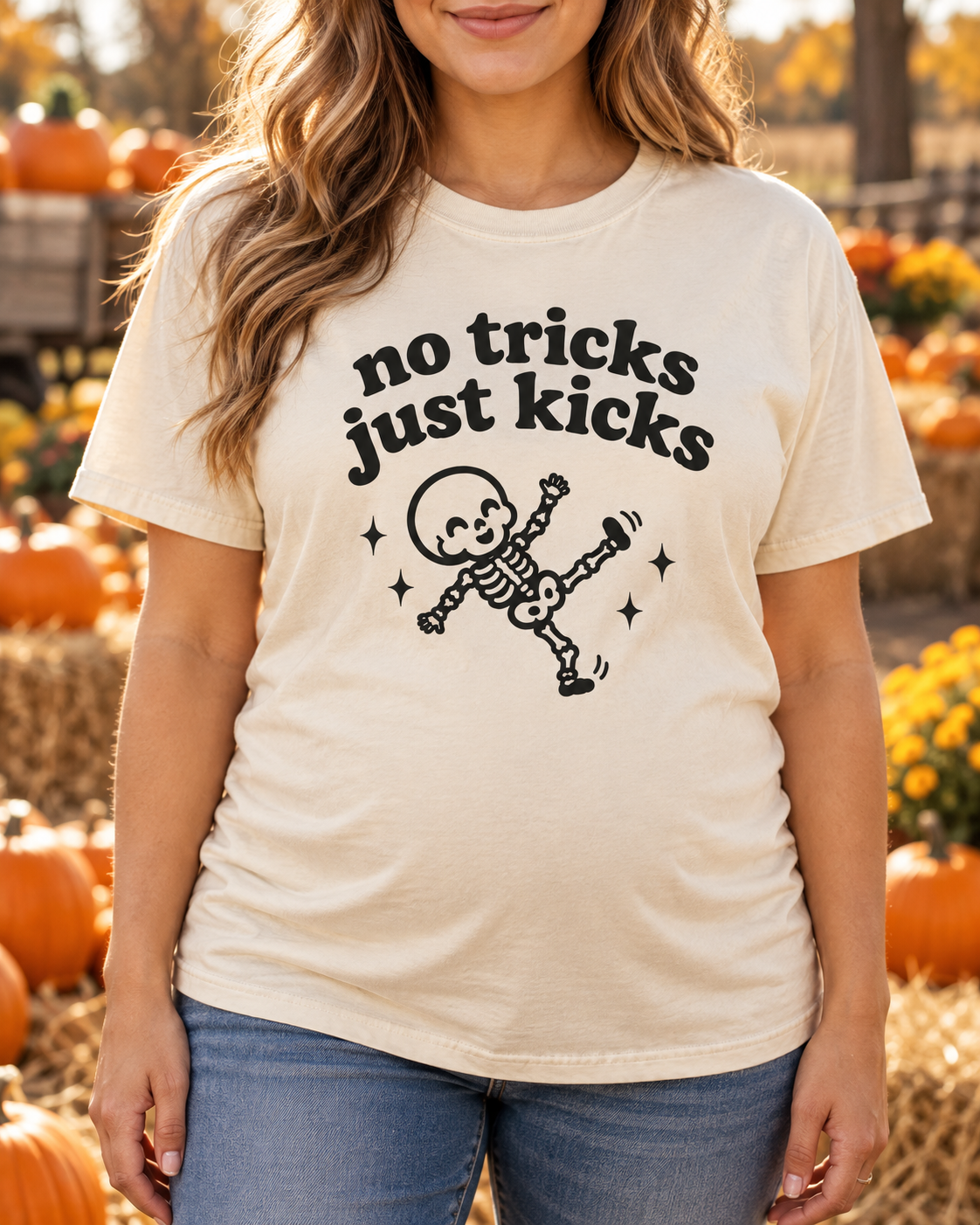 Pregnant model wearing No Tricks Just Kicks baby skeleton tee in Ivory