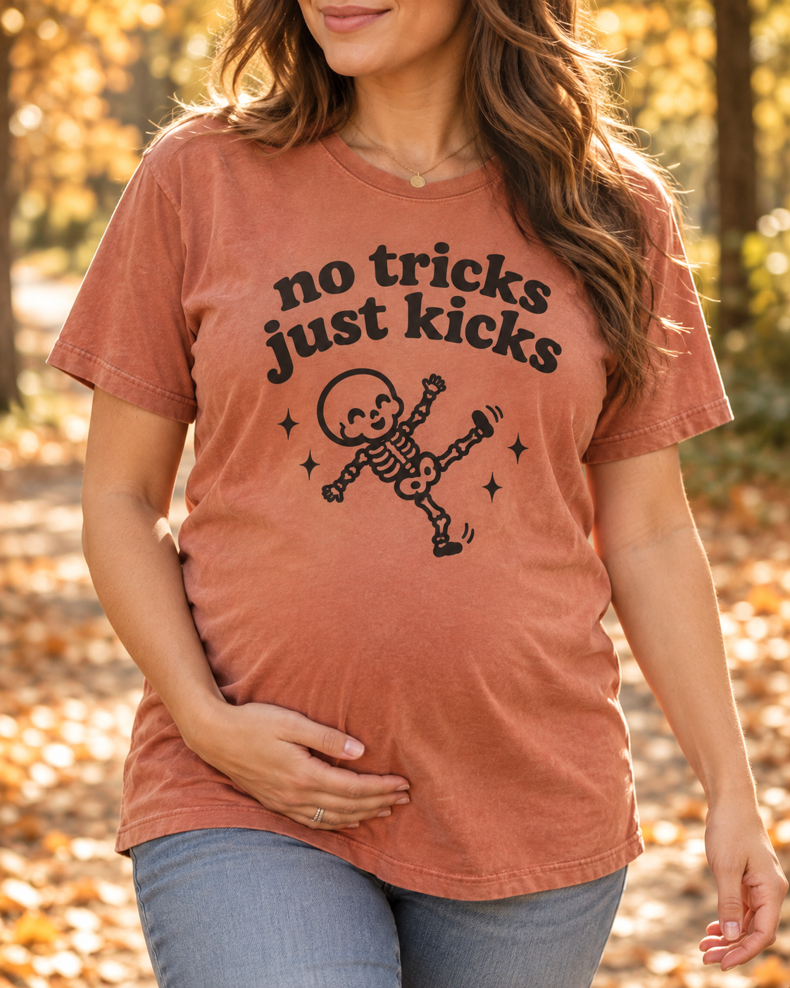 Pregnant model wearing No Tricks Just Kicks Halloween pregnancy tee in Crimson