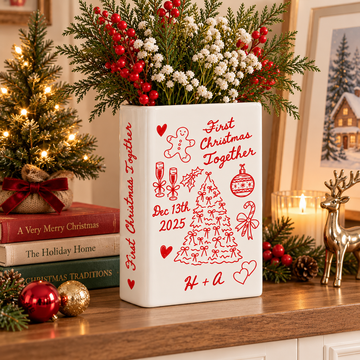 First Christmas Together book vase displayed with festive winter flowers